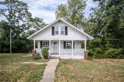 Bungalow with a front yard and covered porch | Image 2