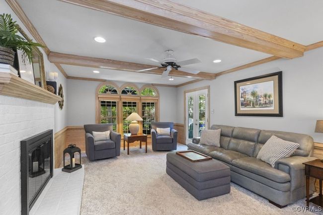 Living room with beamed ceiling, light colored carpet, a fireplace, recessed lighting, and ornamental molding | Image 16
