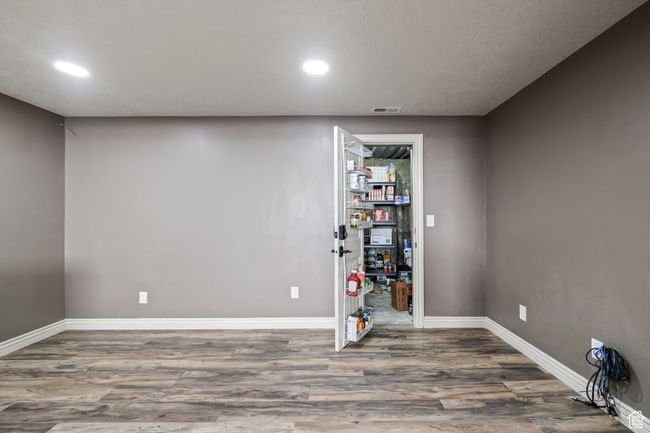 Basement with recessed lighting, visible vents, wood finished floors, and baseboards | Image 31