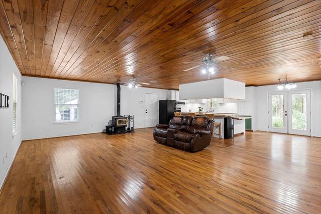Natual Wood and efficent wood burning stove. Open Living/Dining/Kitchen | Image 29