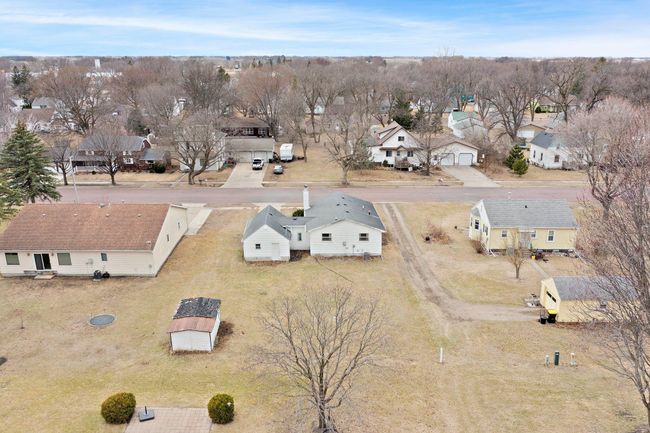 The home features a spacious yard, complete with a large shed for convenient storage of outdoor tools and equipment. | Image 18