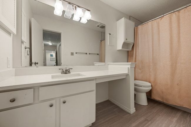 Bathroom with wood finished floors, vanity, and toilet | Image 18
