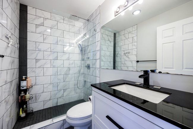 Bathroom featuring toilet, vanity, and a walk in shower | Image 15
