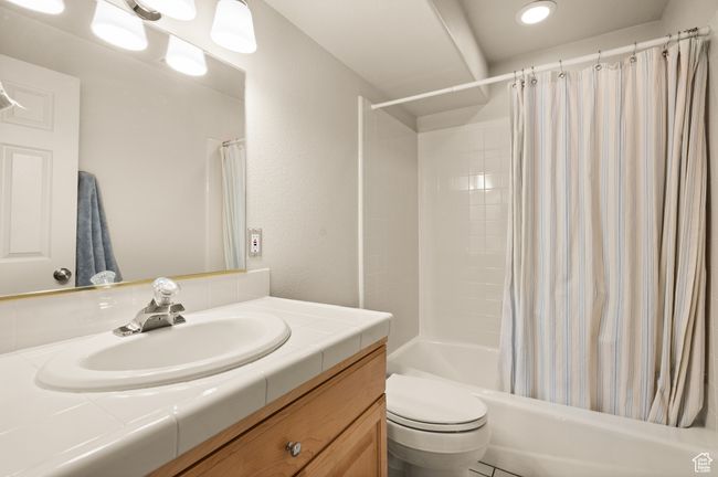 Full bathroom with toilet, vanity, and shower / tub combo with curtain | Image 29