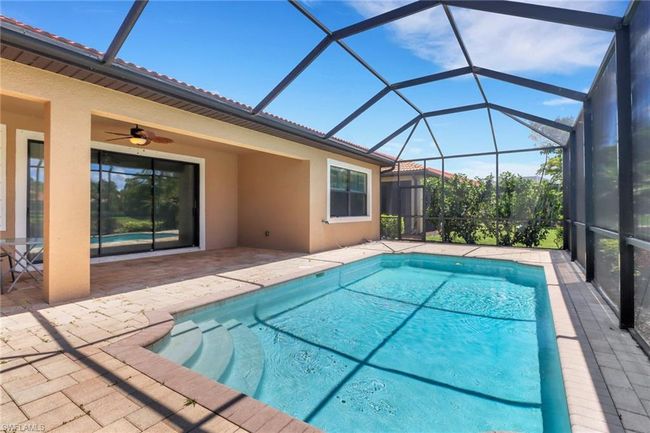 Swimming pool featuring a patio, a ceiling fan, and a lanai | Image 6