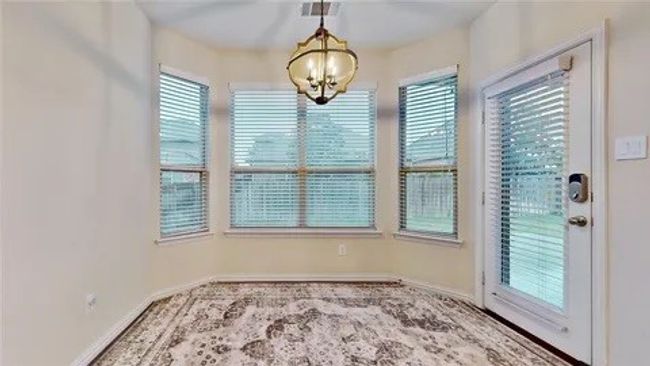 Unfurnished dining area with carpet and a chandelier | Image 4
