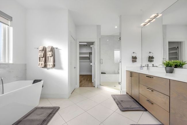 Bathroom featuring tile patterned flooring, vanity, and independent shower and bath | Image 30