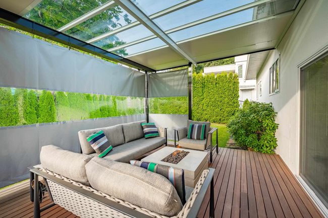 Wooden deck featuring an outdoor living space with a fire pit and a pergola | Image 20