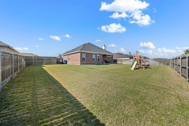 View of yard featuring a fenced backyard and a playground | Image 21