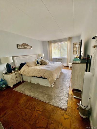 Bedroom with hardwood / wood-style floors and cooling unit | Image 2