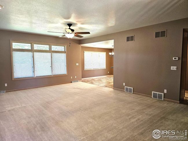 Spacious living room with wall of windows leads to the dining room | Image 4