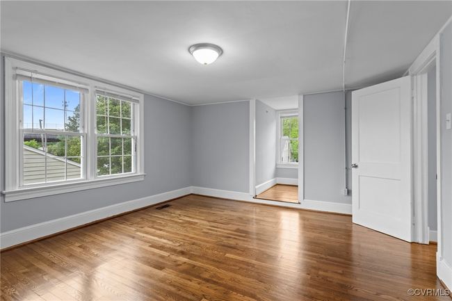 Unfurnished room with baseboards, wood finished floors, and a healthy amount of sunlight | Image 26