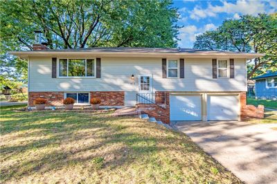 Bi-level home with a garage and a front yard | Image 1