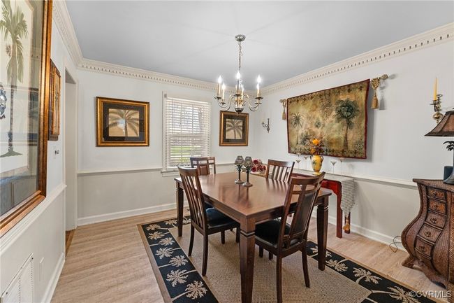 Dining room with visible vents, baseboards, light wood-style floors, and a chandelier | Image 8