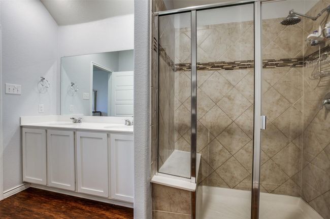 Bathroom with a shower with door and hardwood / wood-style flooring | Image 17