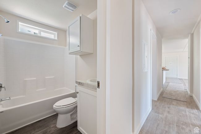 Bathroom with toilet, wood finished floors, vanity, and baseboards | Image 17