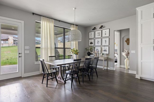 Dining room with dark wood-style flooring and baseboards | Image 12