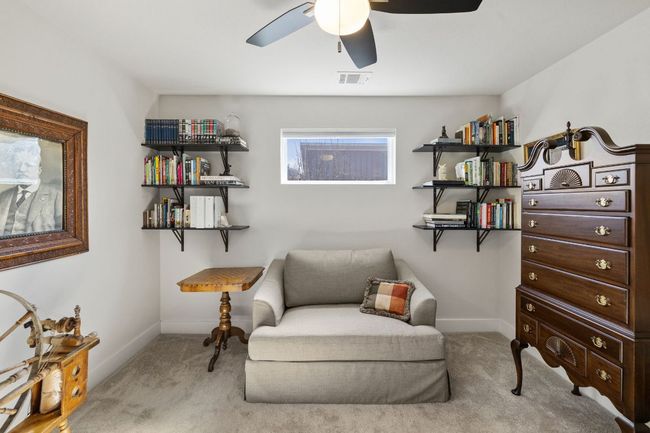 Sitting room featuring carpet flooring, visible vents, baseboards, and ceiling fan | Image 23