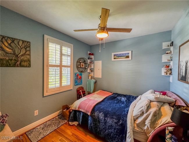 Bedroom featuring wood finished floors, baseboards, and ceiling fan | Image 14