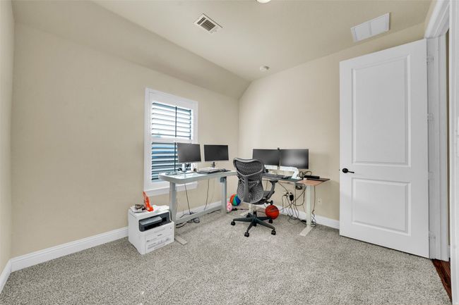Office area with carpet and lofted ceiling | Image 26