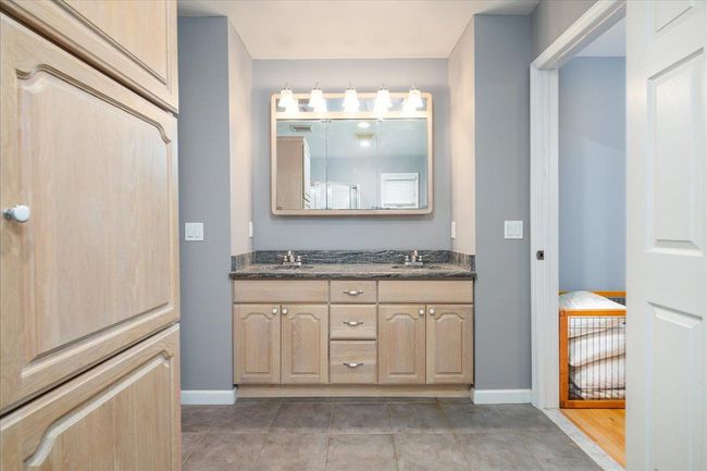 Bathroom featuring double vanity and tile patterned floors | Image 15