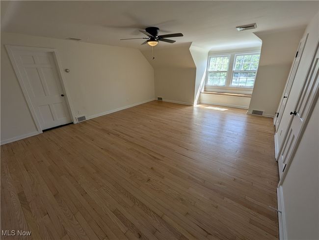 Bonus room with ceiling fan, light wood finished floors, and visible vents | Image 22