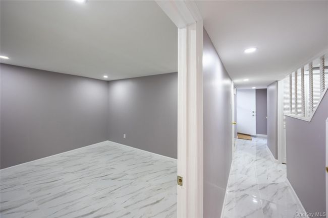 Corridor with marble look tile flooring and recessed lighting | Image 5
