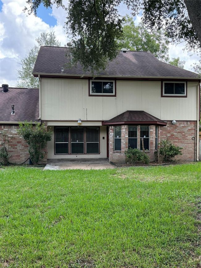 Rear view, double windows, patio for outdoor entertainment. | Image 11