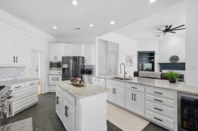 Note HUGE slate-look tile floors for style and functionality. Built-in wine fridge, too! | Image 14