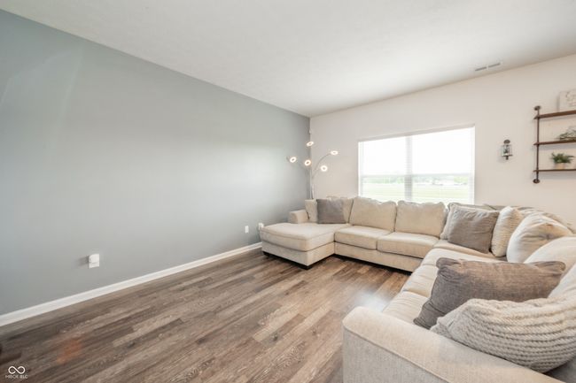 living area featuring wood finished floors and baseboards | Image 8