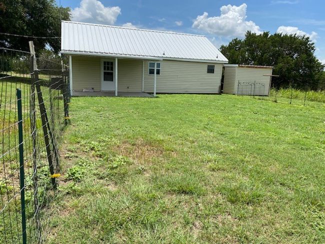 Back of property with a metal​​‌​​​​‌​​‌‌​‌‌​​​‌‌​​‌‌​‌​​​​​‌ roof | Image 12