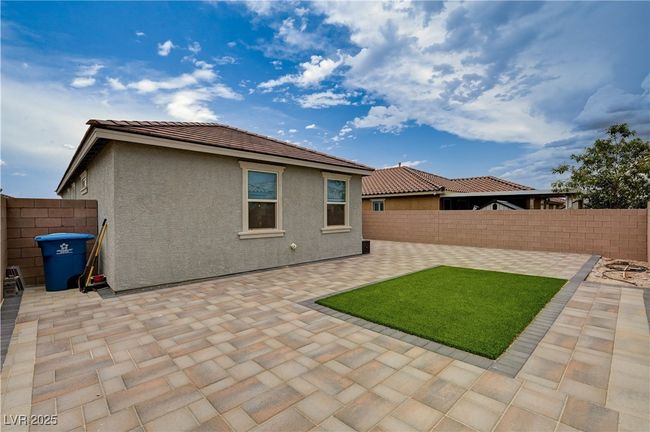 Rear view of property with a fenced backyard, a patio area, and stucco siding | Image 32