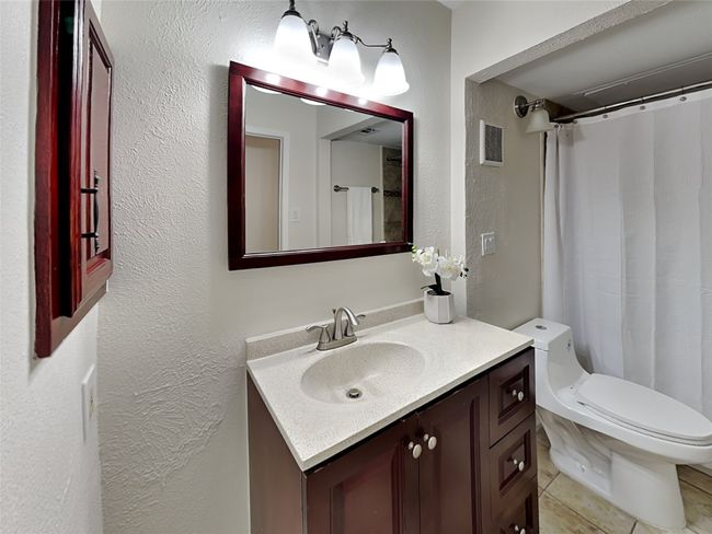 Full bath with a textured wall, visible vents, vanity, and toilet | Image 15
