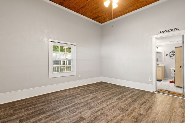 Spare room with baseboards, wood finished floors, wood ceiling, and ornamental molding | Image 24