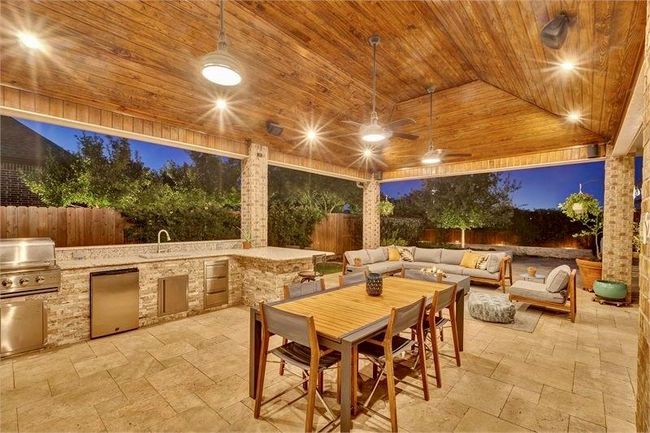 The home features an impressive covered outdoor patio. | Image 46