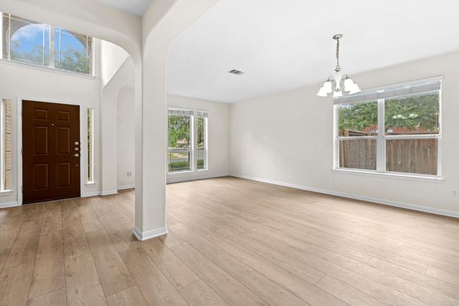 Foyer featuring a chandelier, light wood-type flooring, and arched walkways | Image 4