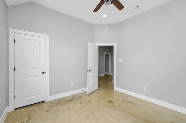 Unfurnished bedroom with baseboards, concrete floors, ceiling fan, and recessed lighting | Image 22
