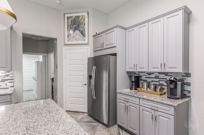 The kitchen is thoughtfully designed with ample storage solutions, making it both practical and aesthetically pleasing. | Image 16
