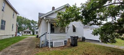 View of property exterior with a yard | Image 3