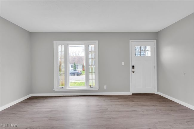 Entrance foyer with baseboards and wood finished floors | Image 5