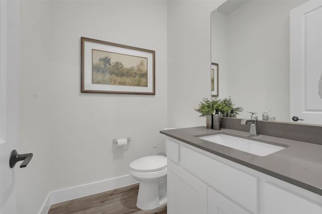 Bathroom featuring baseboards, wood finished floors, vanity, and toilet | Image 21