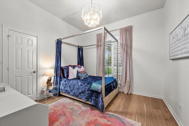 One of the secondary bedrooms features an elegant canopy bed and rich velvet drapes—full of charm and personality. | Image 26