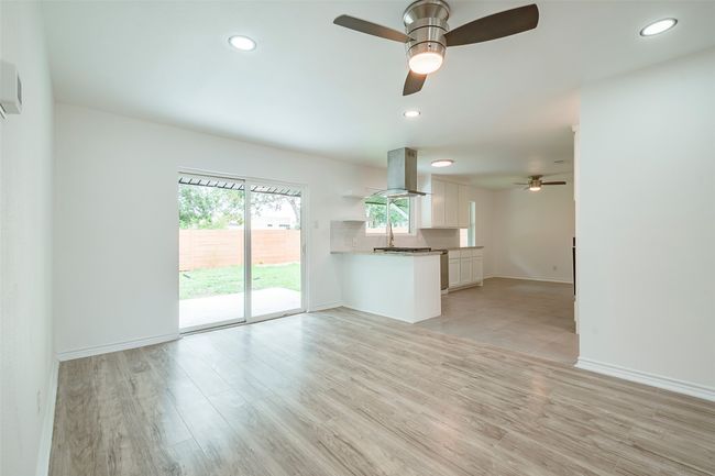 Unfurnished living room featuring ceiling fan, light wood-style floors, and recessed lighting | Image 8