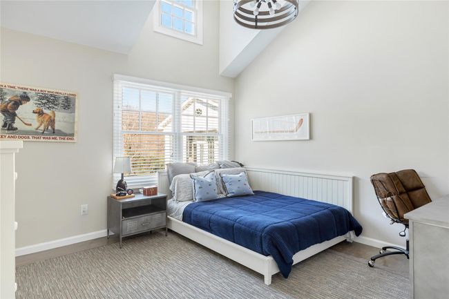 Bedroom with a high ceiling and baseboards | Image 43