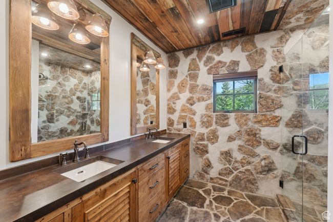 Full bathroom featuring wood ceiling, double vanity, and a shower stall | Image 31