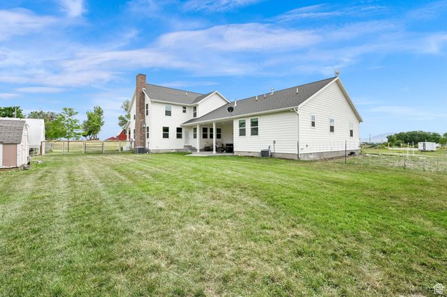 Rear view of house with a patio area and a storage shed | Image 4