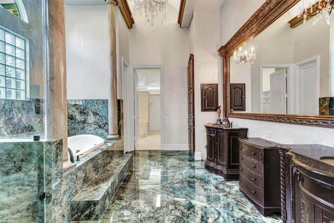 No need to travel to a spa when you can step into your very own primary bath! The marbled floor that flows to the tub and even the shower is a luxurious touch you will love. | Image 23