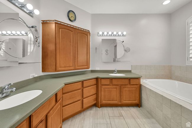 Bathroom with recessed lighting, a garden tub, double vanity, and a sink | Image 31