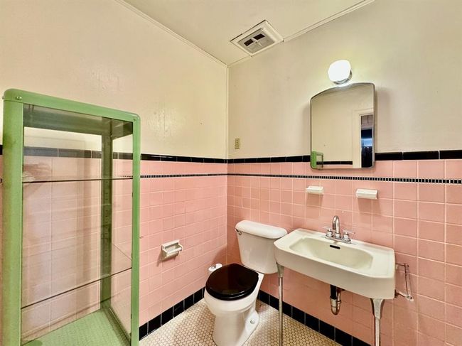 Bathroom featuring a shower stall, a wainscoted wall, tile walls, and tile patterned flooring | Image 21