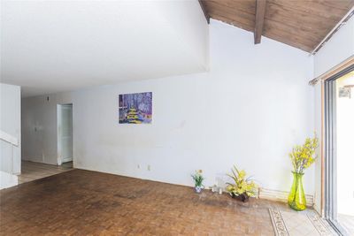 living room with open stairwell has a skylight for a brighter living area. | Image 3